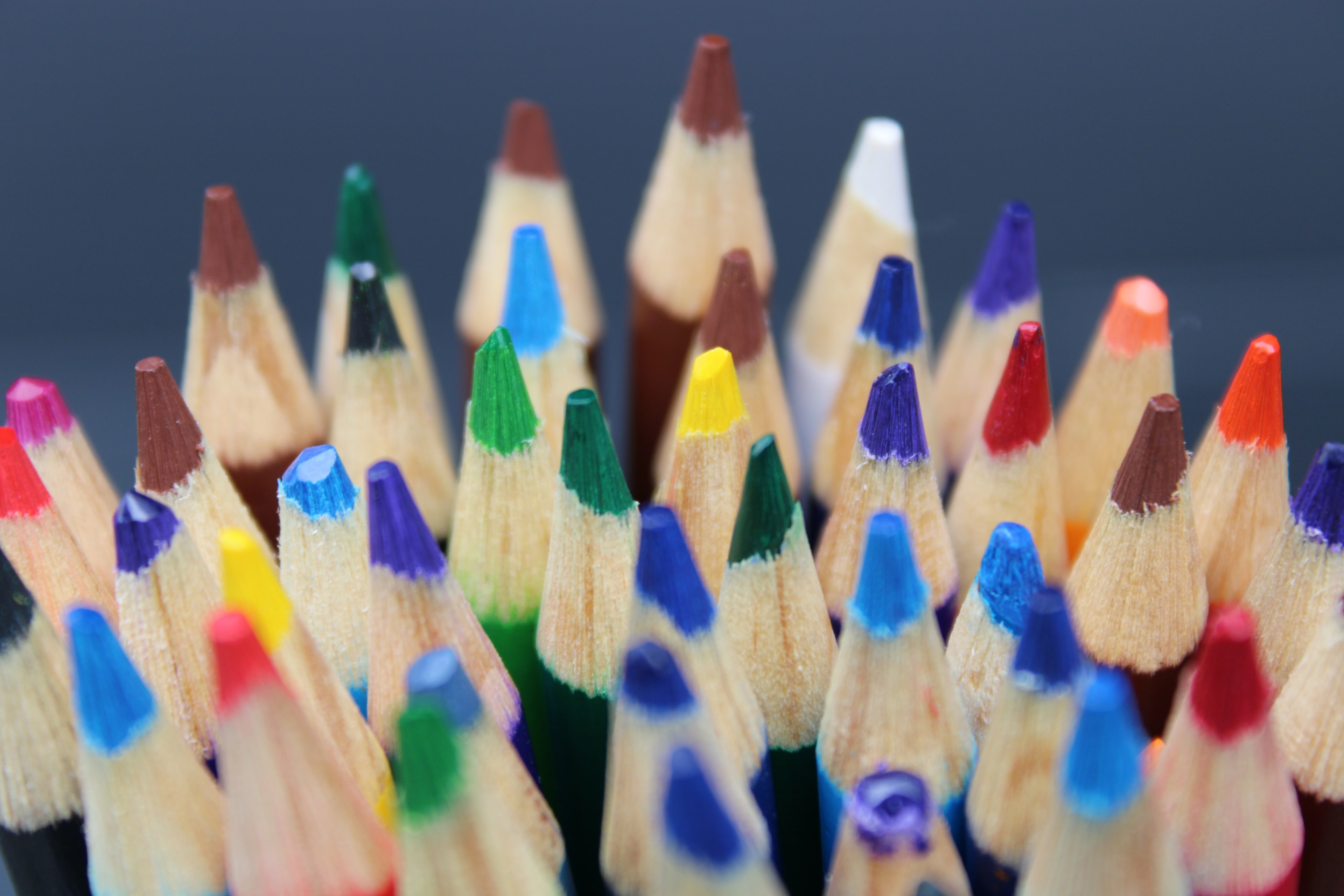 Colored pencil tips pointing upward, sharp and colorful
